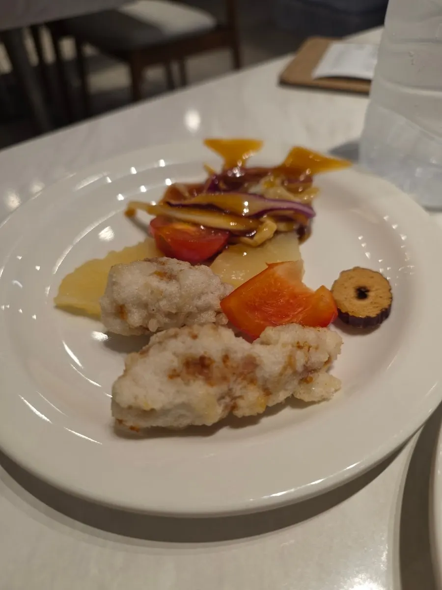 A piece of tangsuyuk dipped in sauce