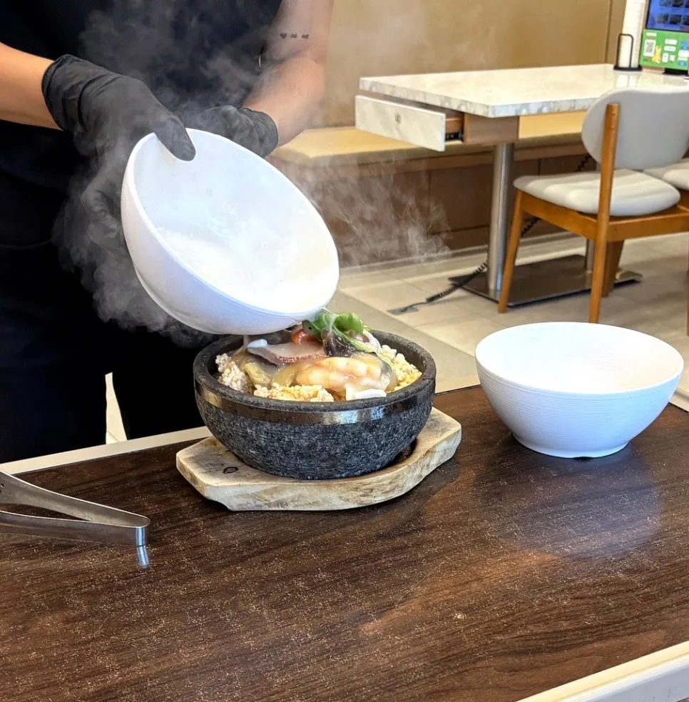Seafood nurungjitang being poured into the stone pot