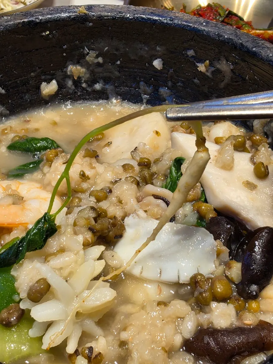 A spoonful of nurungjitang with mung beans mixed in
