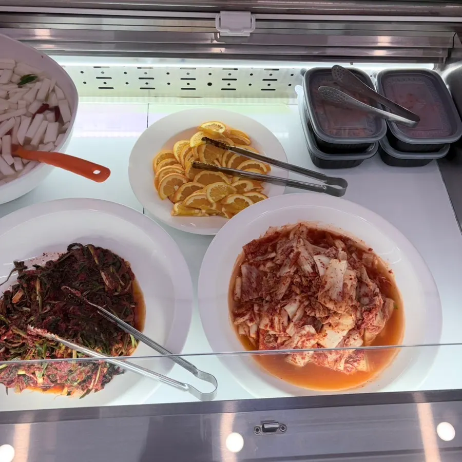 Kimchi, green onion kimchi, and orange side dishes