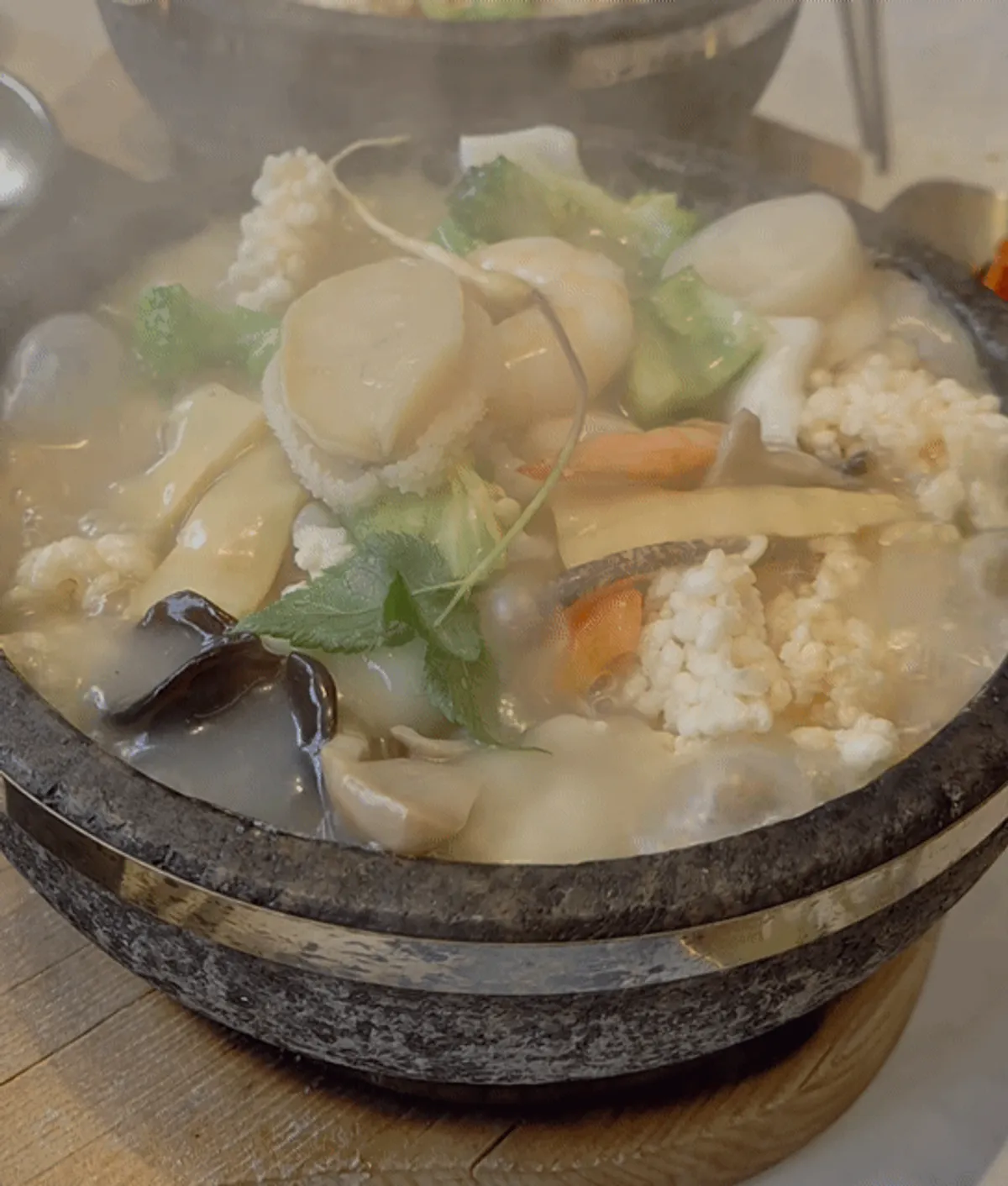 Seafood abalone rice soup served in a hot stone pot