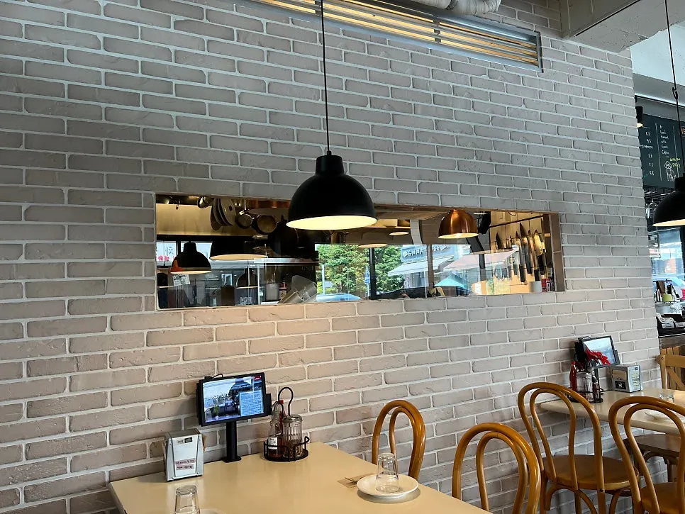 Interior with wood-tone tables and lighting