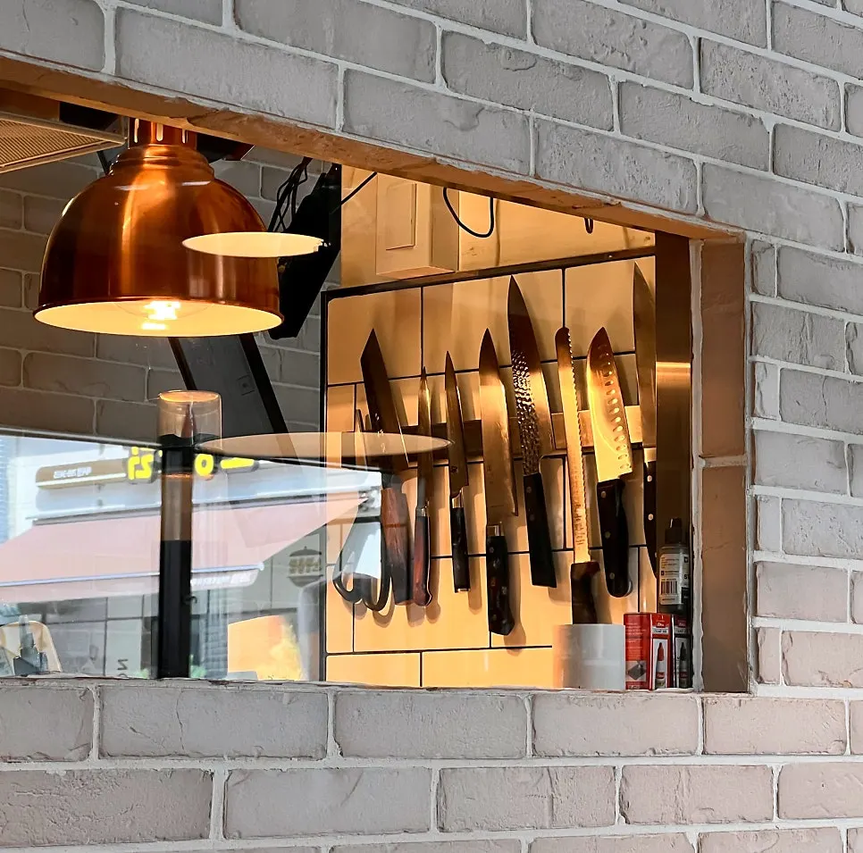 Interior of The Pizzeria Market showing the open kitchen