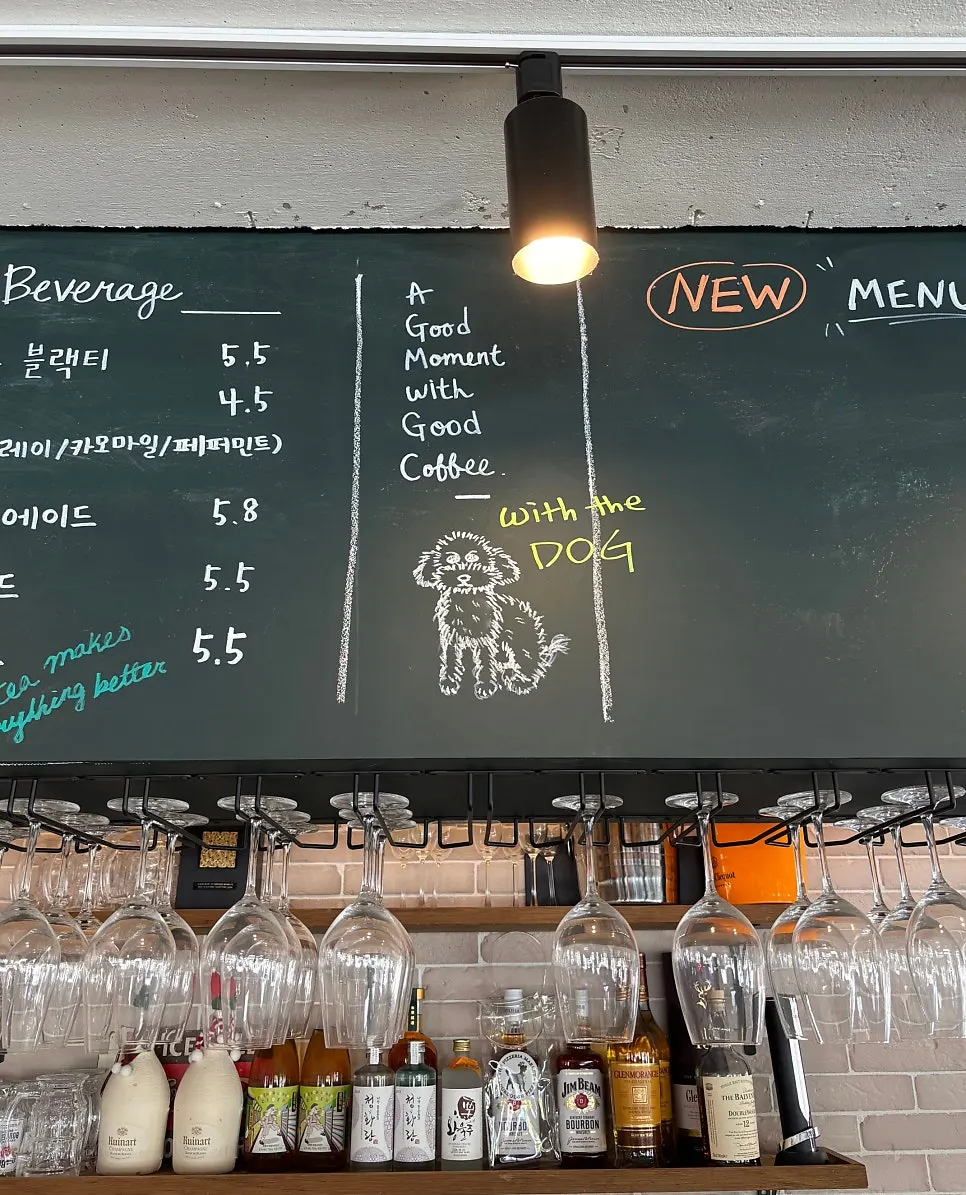 Menu board above the counter with a dog illustration