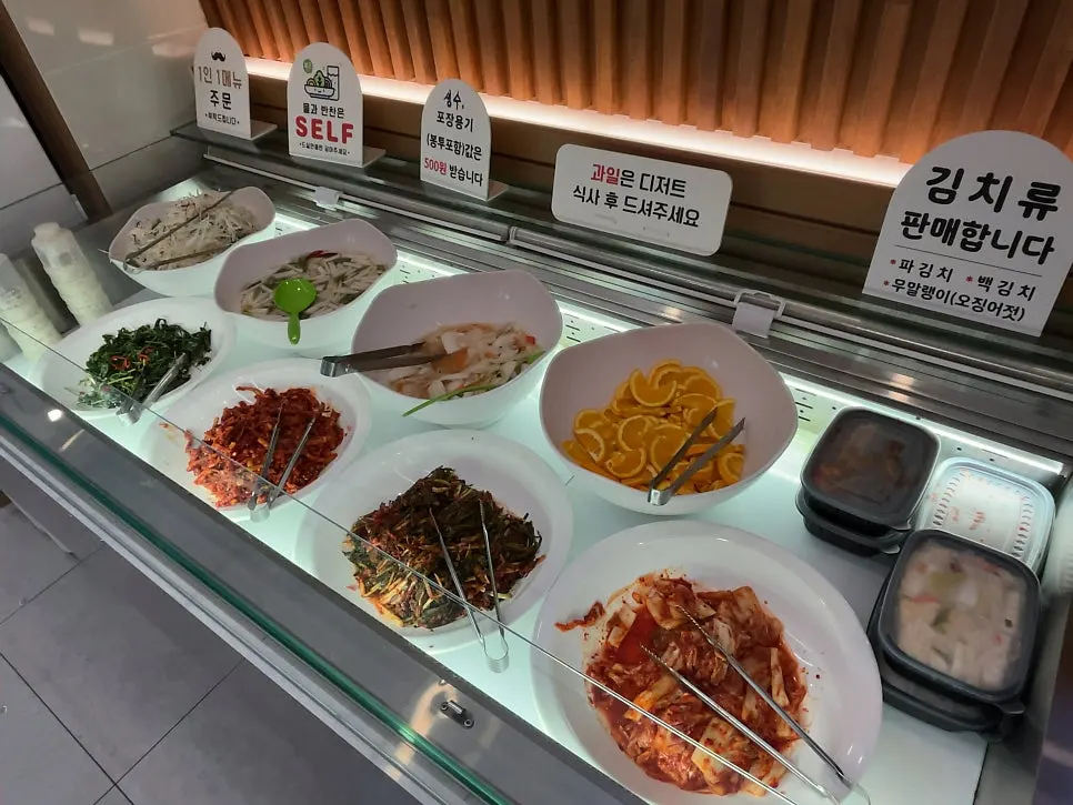Self-service bar with seasoned vegetables and greens