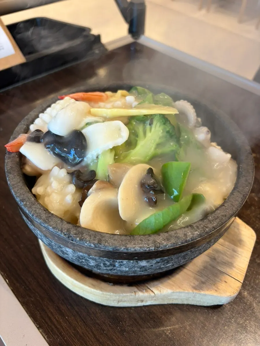 Close-up of seafood scorched-rice soup packed with seafood
