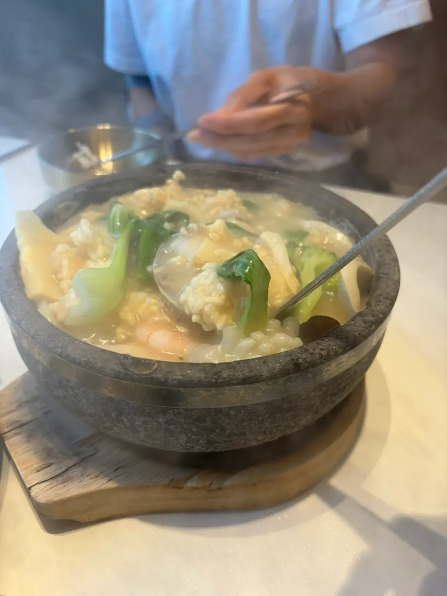 A spoonful of scorched rice soaked in broth