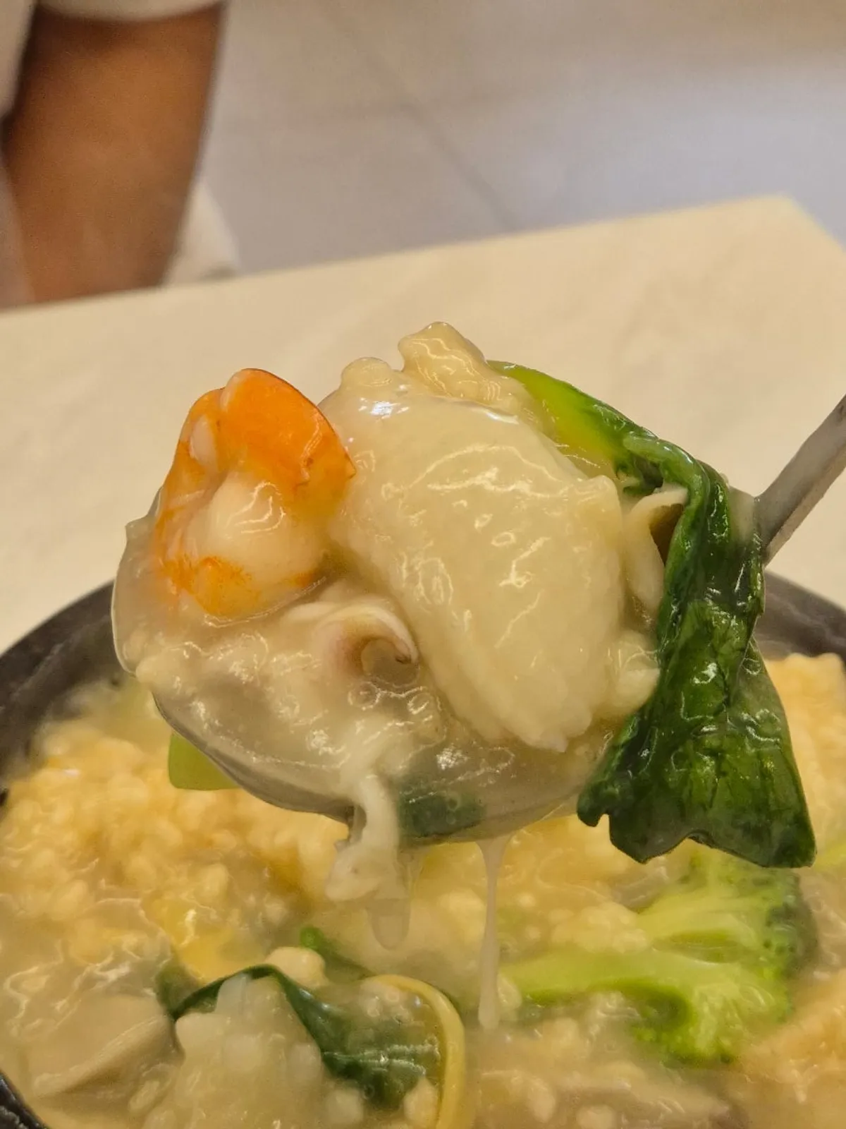 Seafood nurungjitang poured into a stone pot