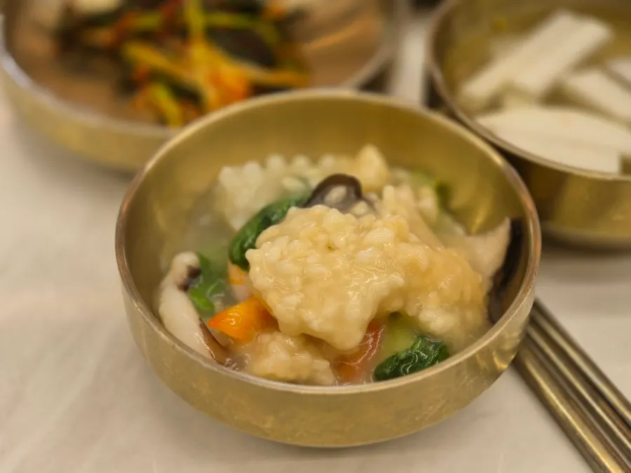 Close-up of the nurungjitang packed with vegetables and seafood