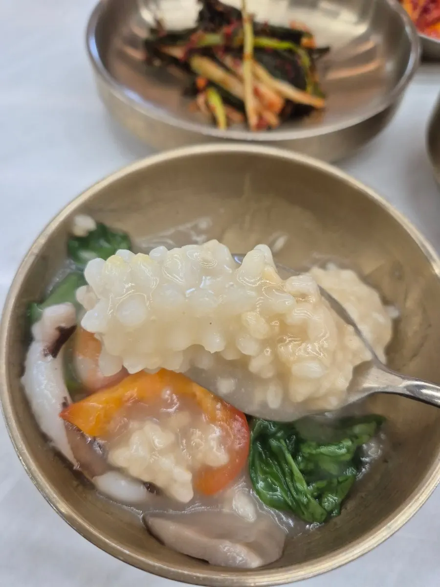 A ladleful of seafood nurungjitang scooped up