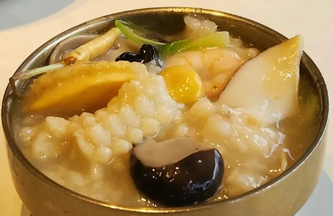 Thick nurungjitang broth ladled into a bowl