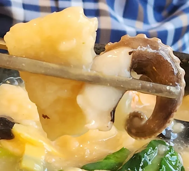 A bowl of nurungjitang with abalone and scallop