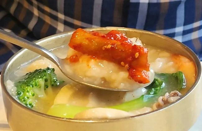 Table setting of two servings of seafood abalone nurungjitang