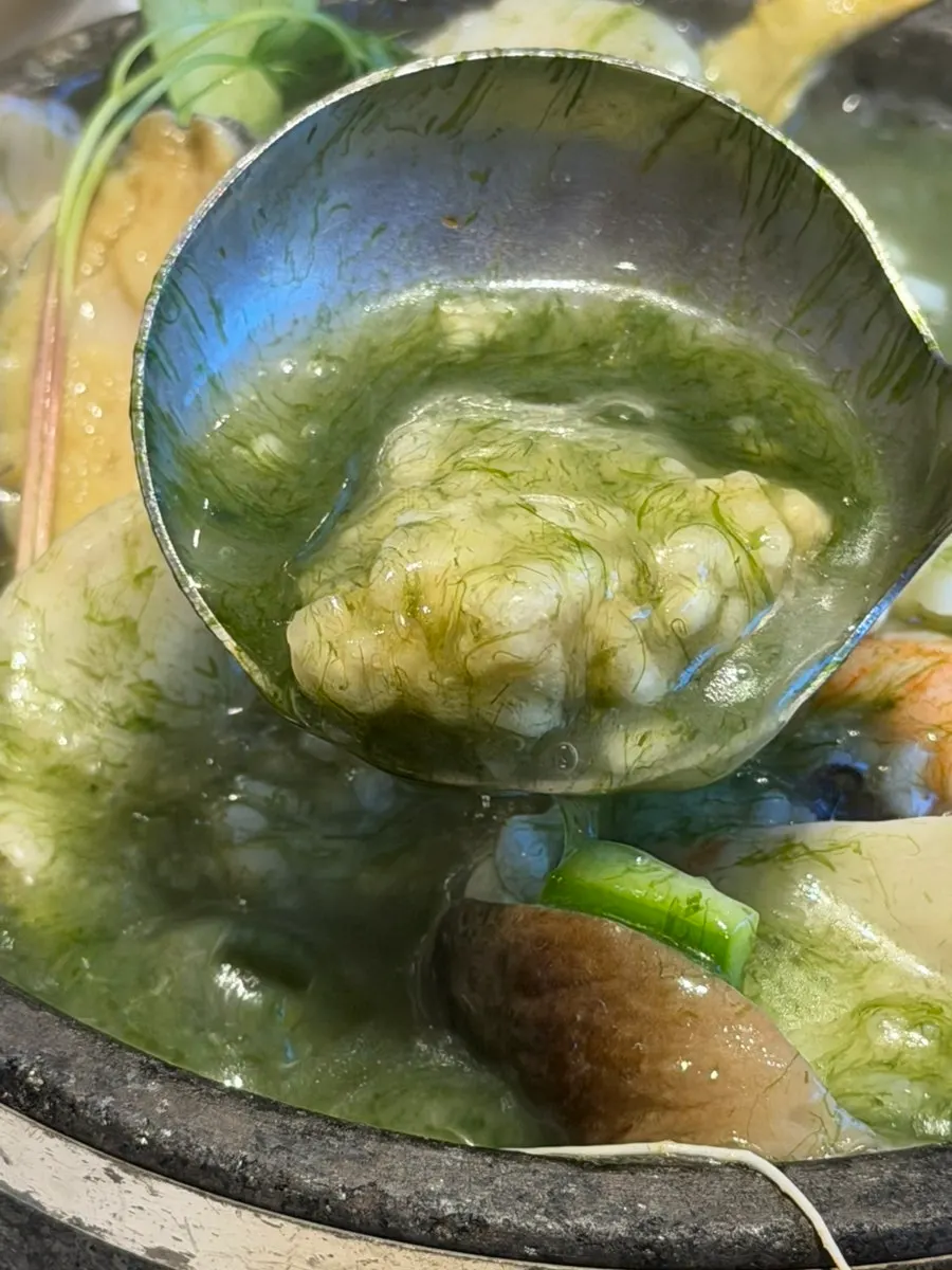 A spoonful of seafood scooped from the nurungjitang