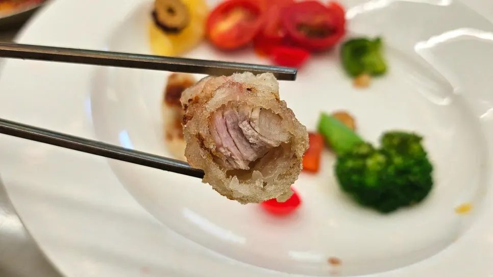 A piece of tangsuyuk dipped in sauce
