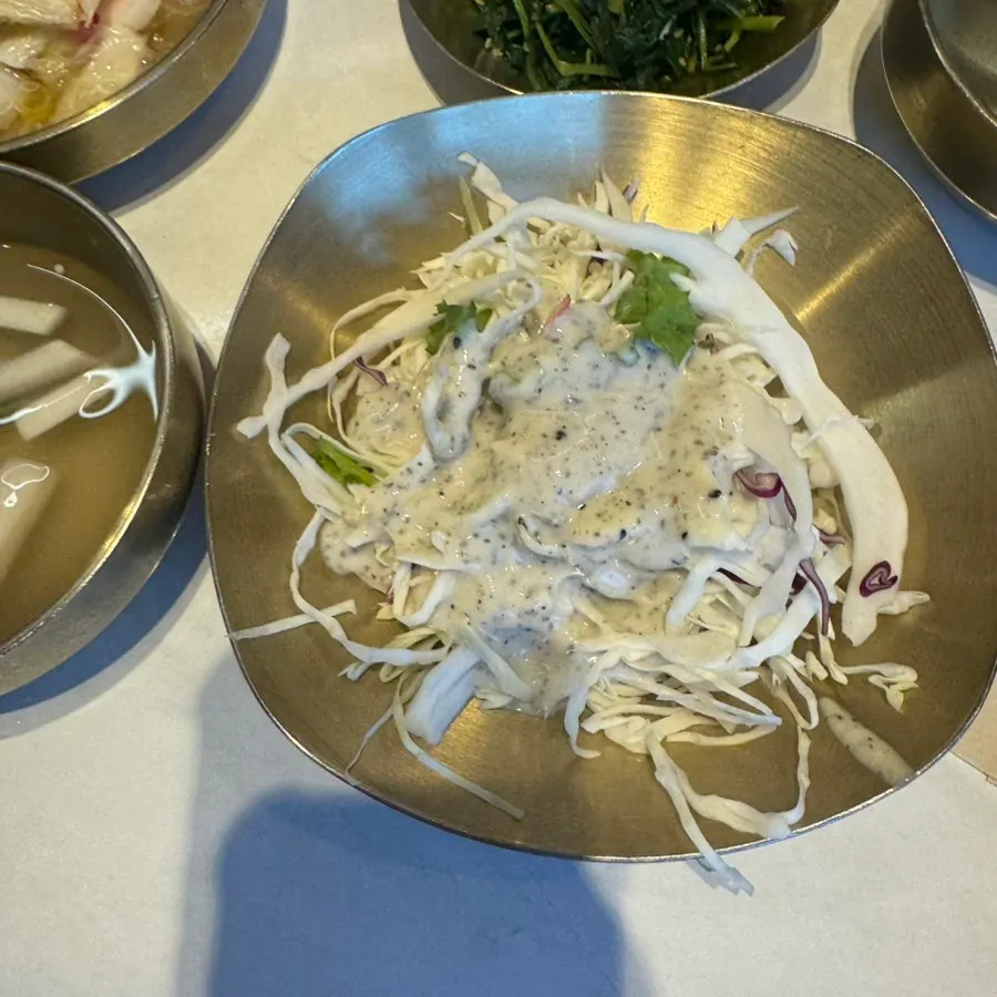 Plates of basic Chinese restaurant side dishes on the table
