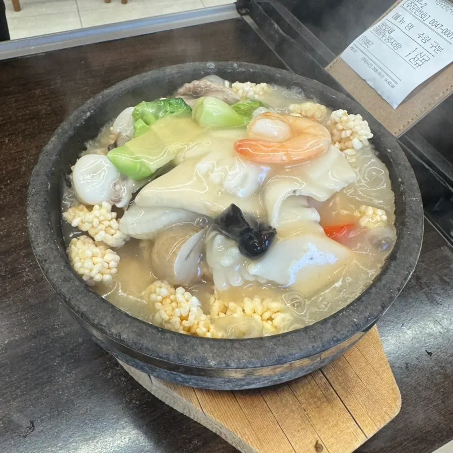 Close-up of seafood from a scooped serving of palbochae