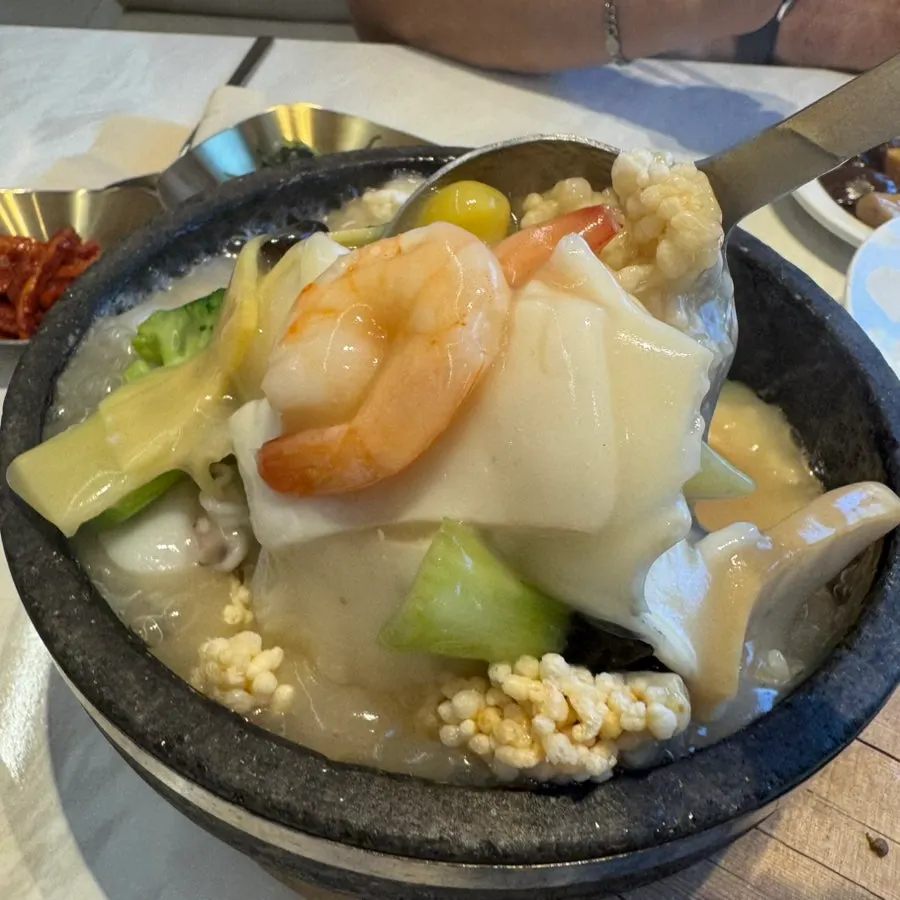 A ladleful of scorched rice soaked in broth