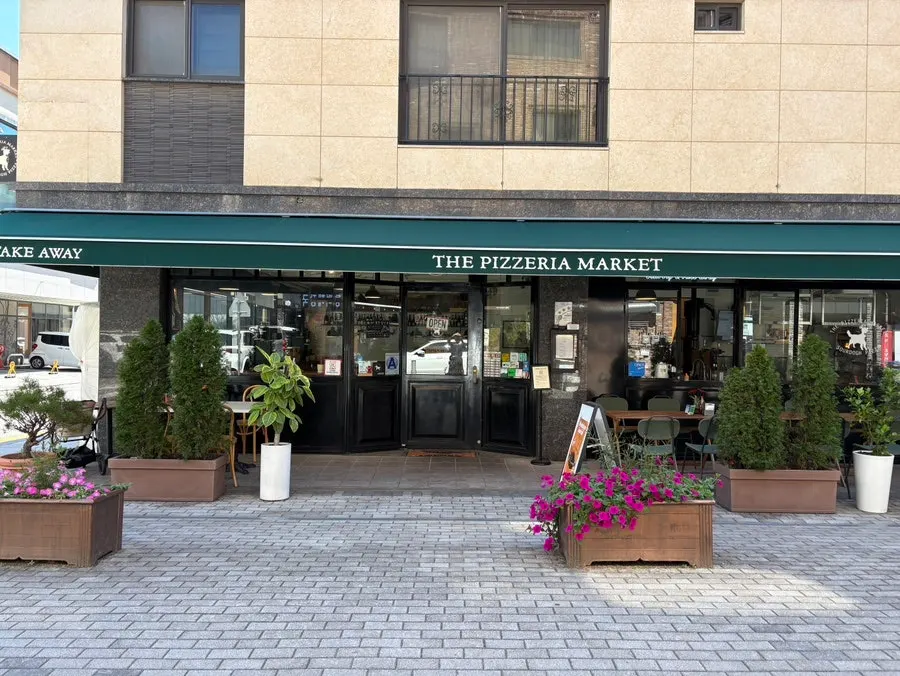 Exterior of The Pizzeria Market Hanam Misa with green awning