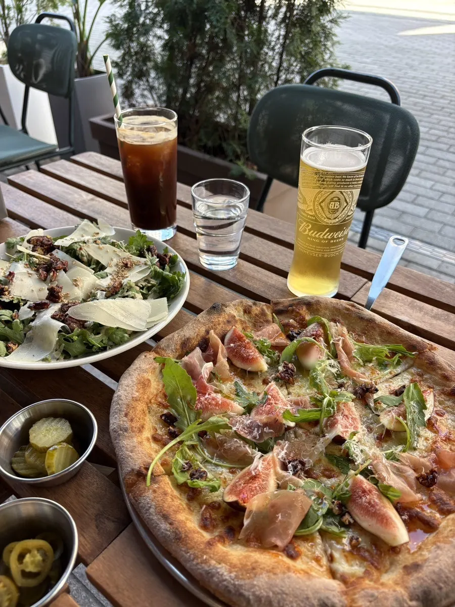 Slice of fig prosciutto pizza drizzled with hot honey