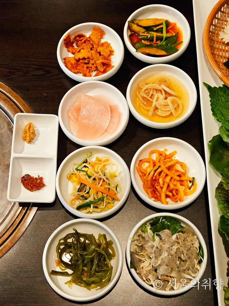 Home-style side dishes served as a 12-item banchan spread