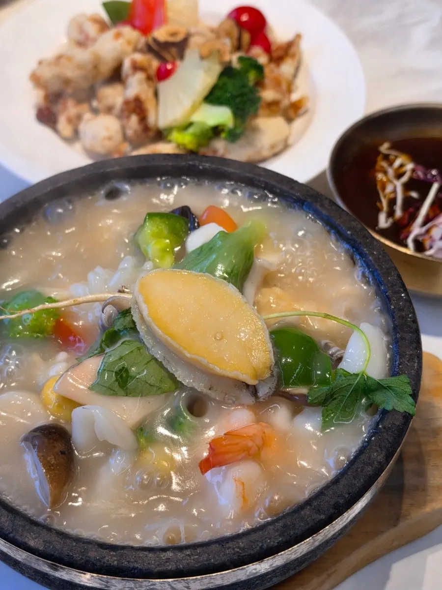 Bubbling stone pot of seafood abalone rice soup