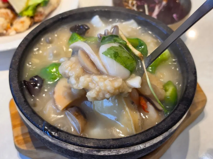 Rice soup broth loaded with abalone and seafood
