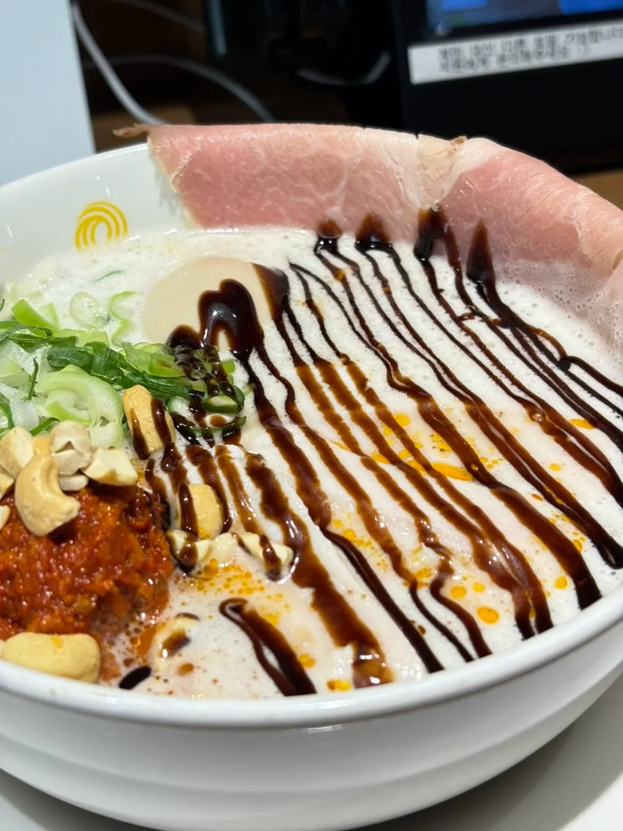 Close-up of kara tantanmen topped with cashews