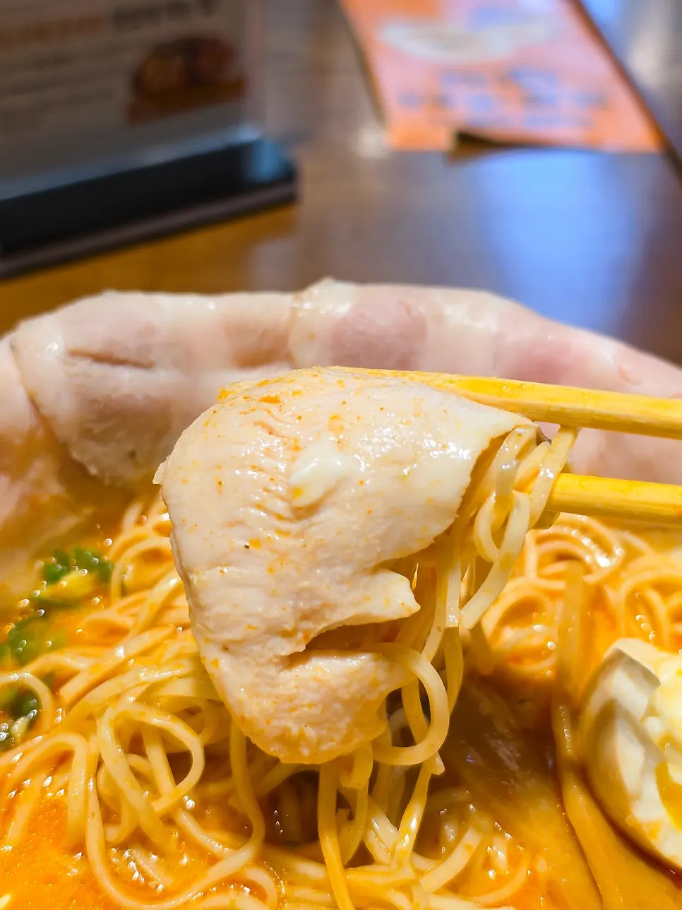 Handmade whole wheat fresh noodles in the spicy tori paitan ramen