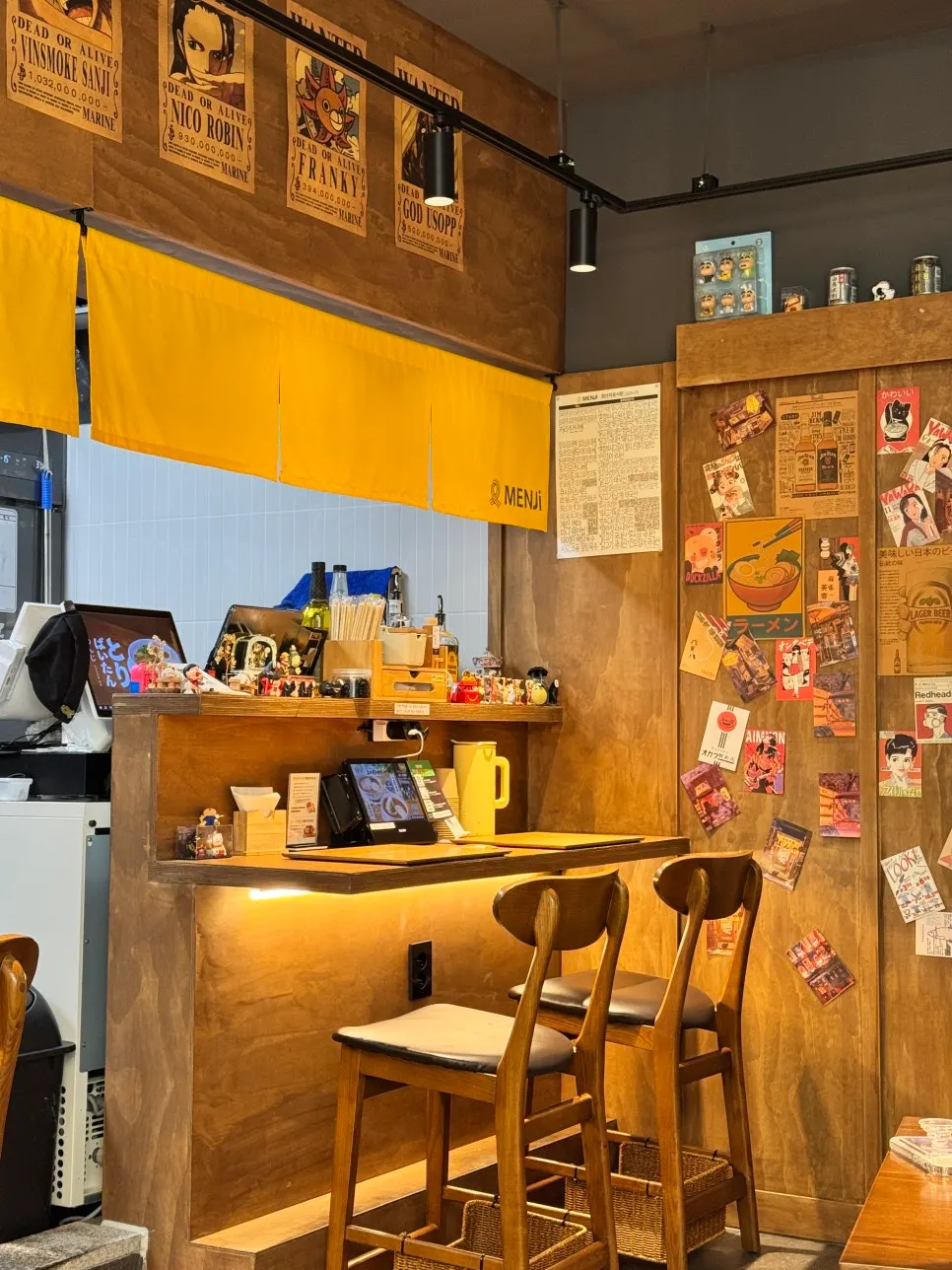 Japanese anime posters covering the wall