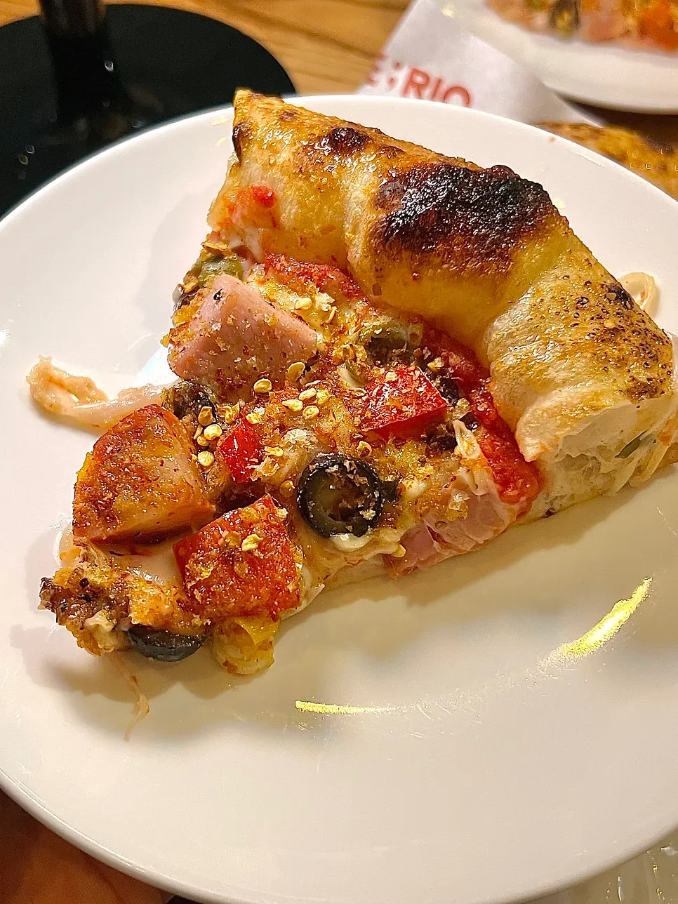 Cross-section of the pizza showing the chewy wood-fired crust
