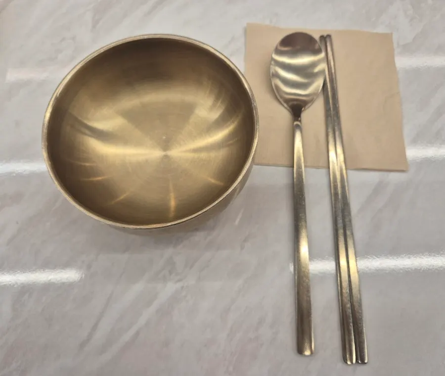 Table set with brass individual dishes and cutlery
