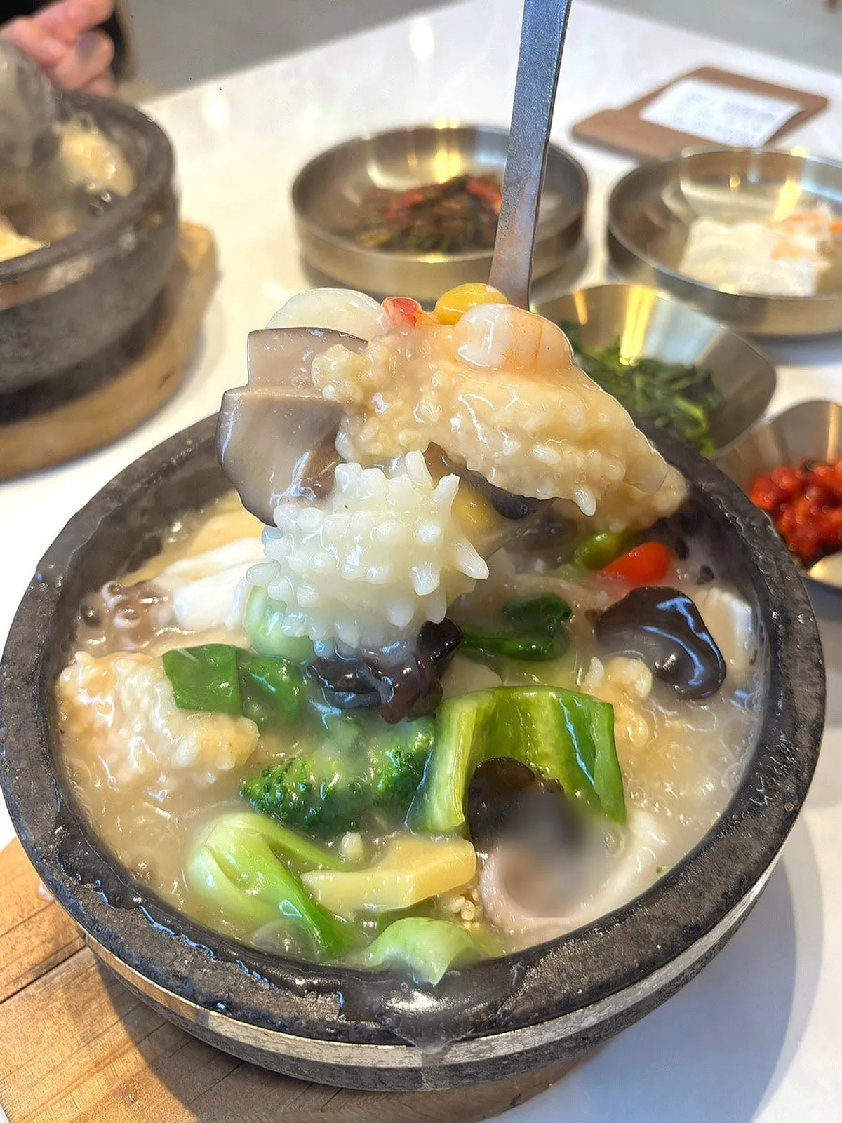 Single-serving stone pot seafood nurungjitang loaded with seafood