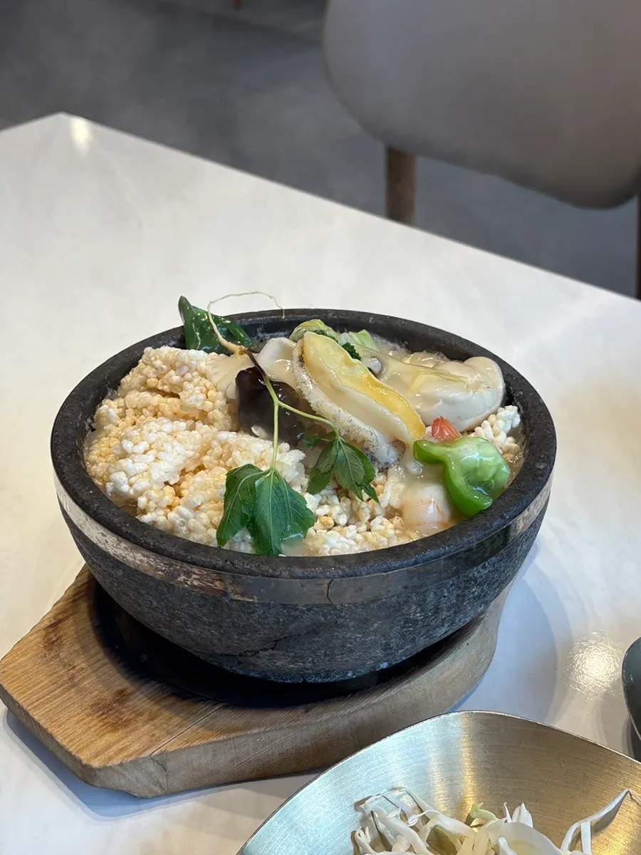 A steaming bowl of seafood nurungjitang