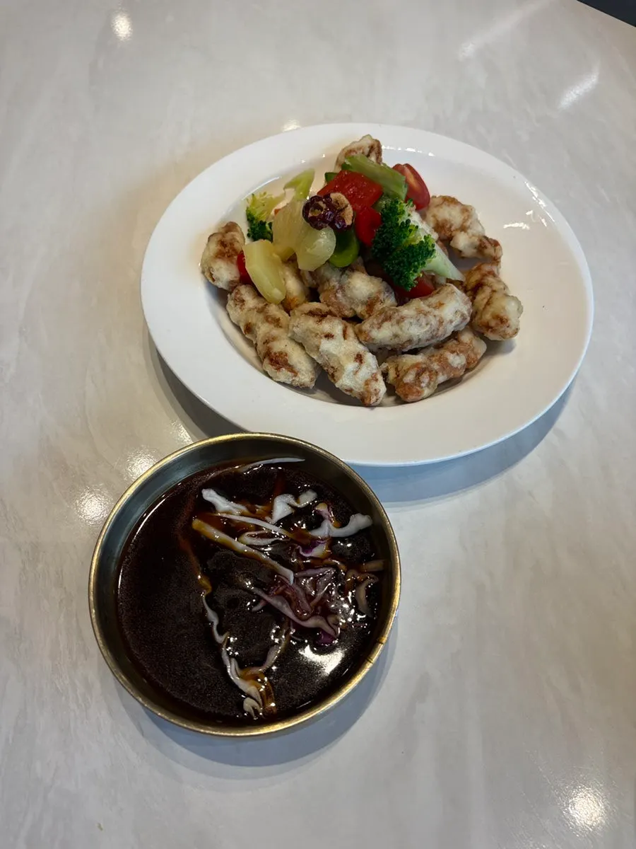 Sweet rice tangsuyuk topped with fruit and vegetable garnish