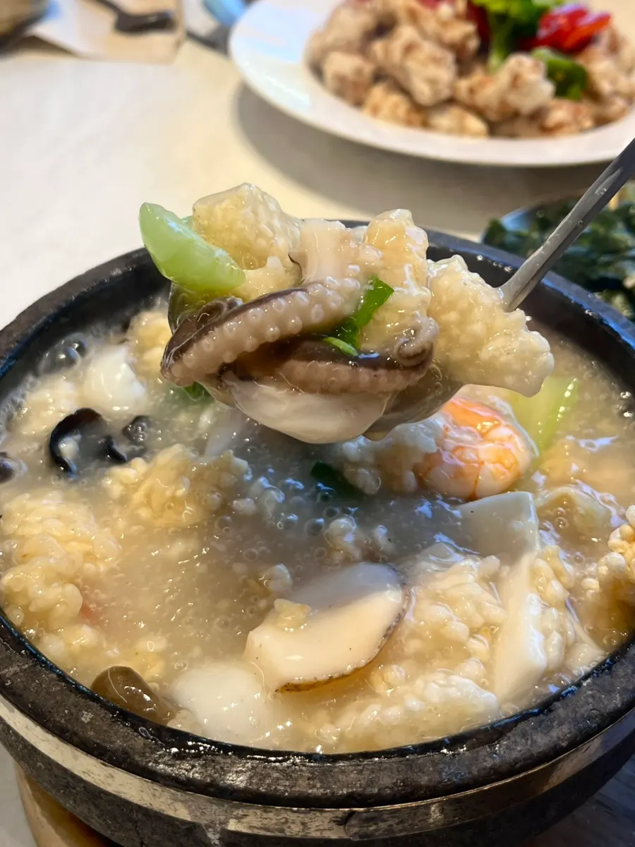 A spoonful of seafood nurungjitang lifted up