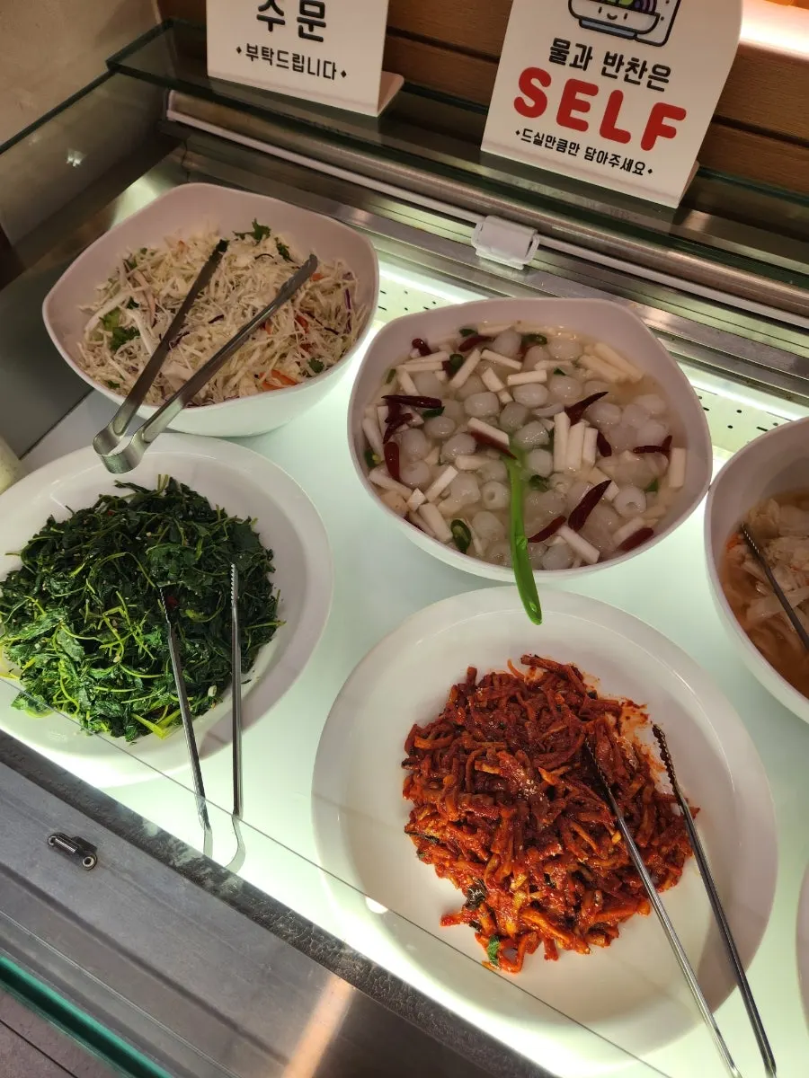 Self-serve bar with side dishes and fruit