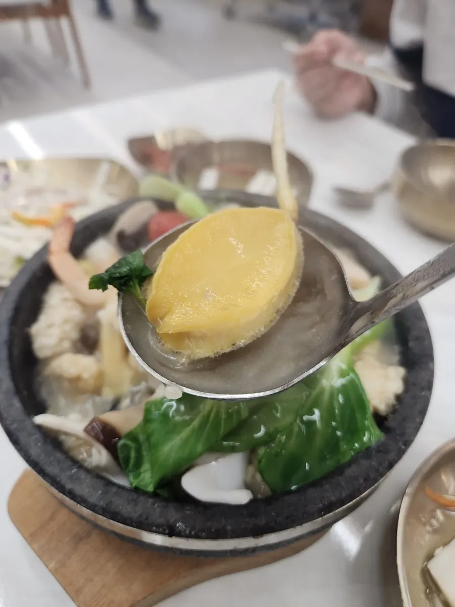 Broth and seafood in the hot stone pot nurungjitang