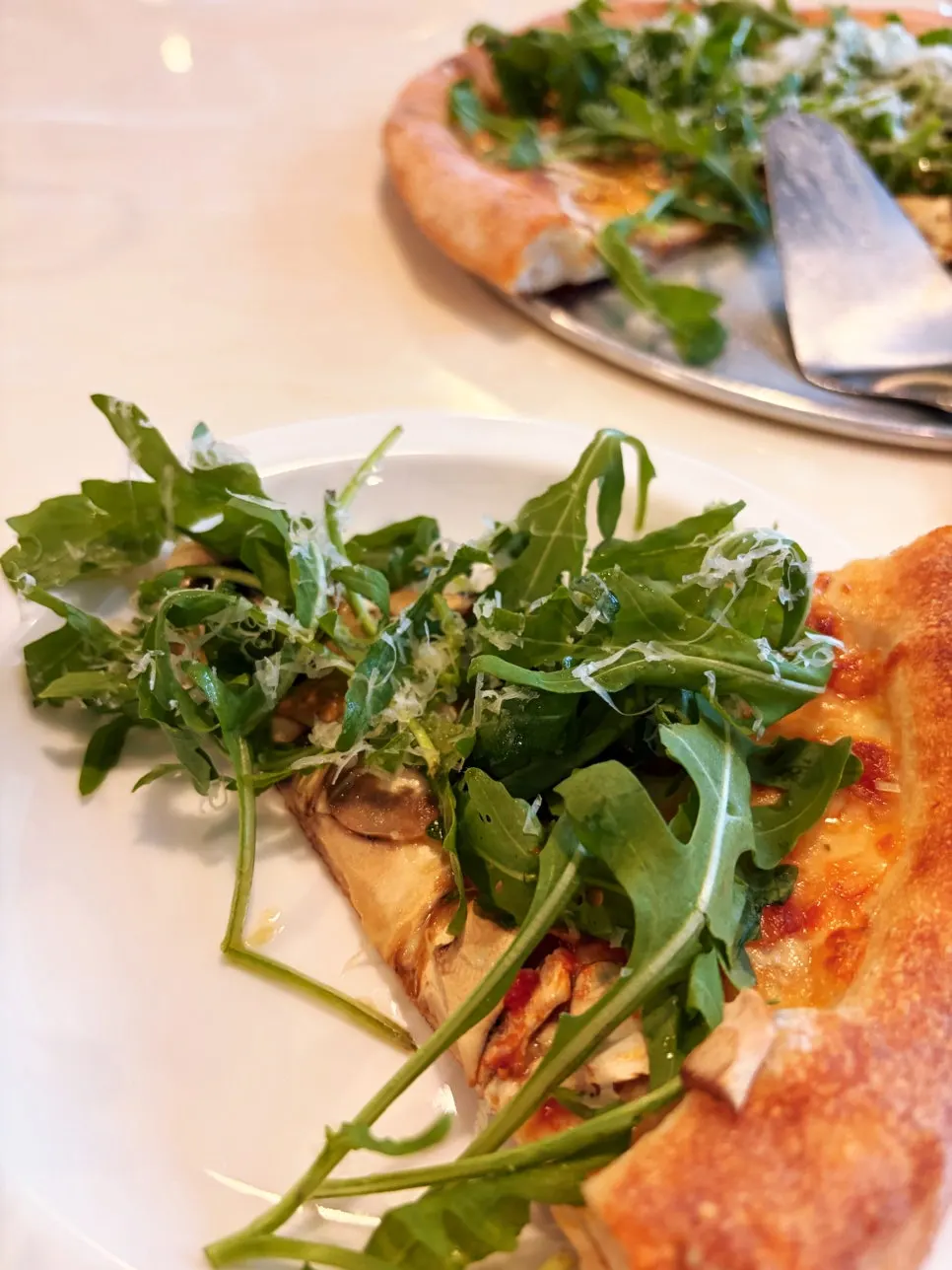 Truffle mushroom wood-fired pizza topped with arugula