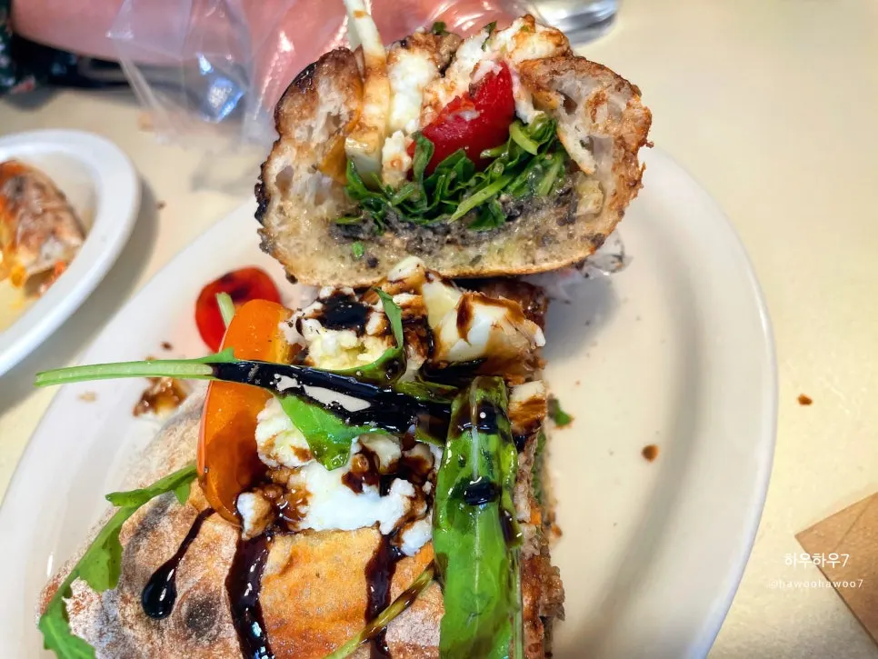Pizza boat piled with toppings on wood-fired sourdough