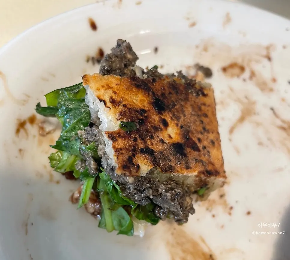 A slice of the pizza boat topped with stracciatella cheese