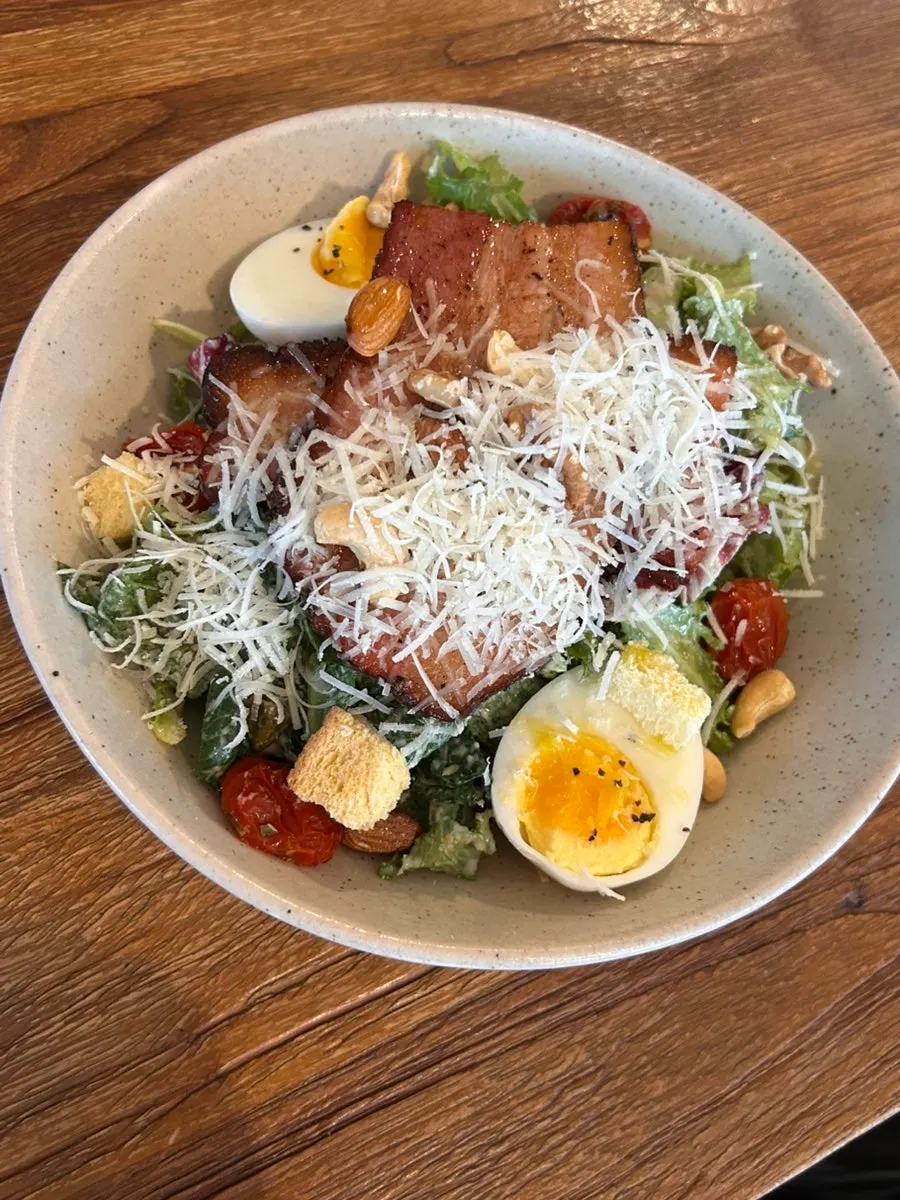 A plate of Bokkeriu's homemade bacon Caesar salad