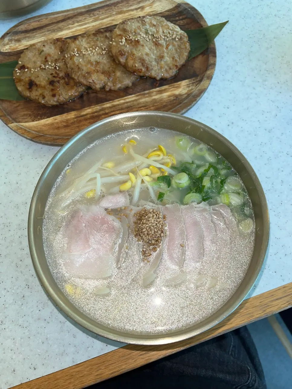 Bone-broth pork noodle soup topped with meat and bean sprouts
