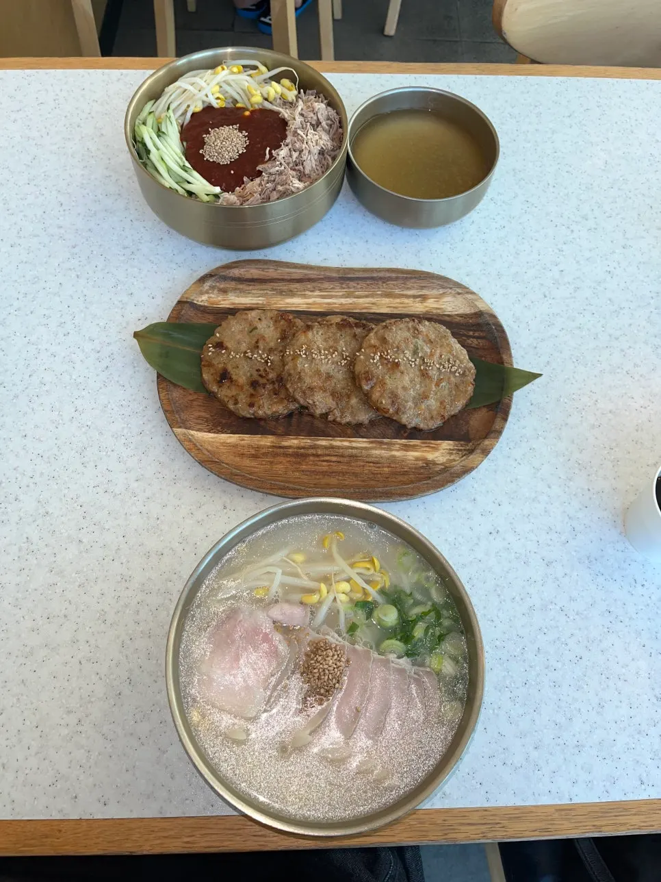 Two bowls of noodles and tteokgalbi set for two people