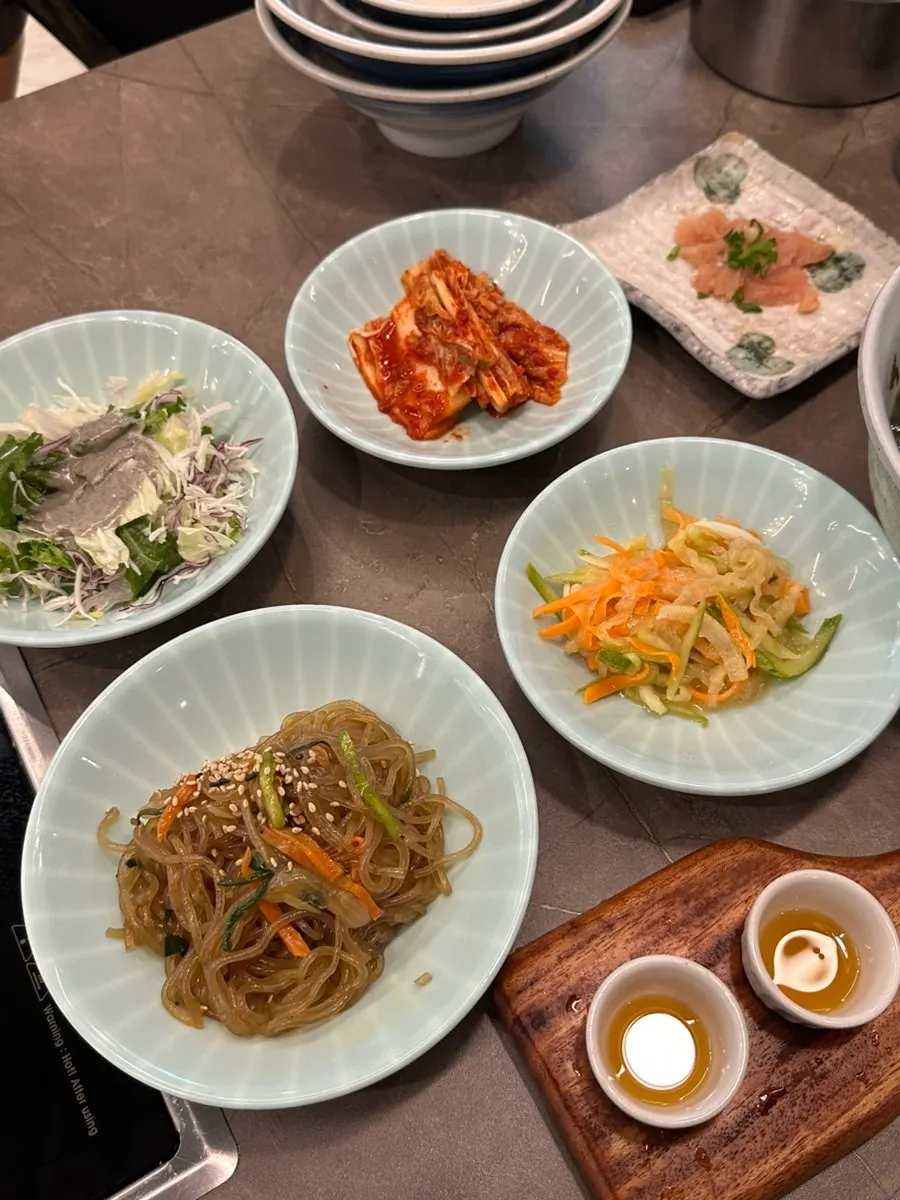 Side dish spread including cold mixed vegetables and seaweed soup
