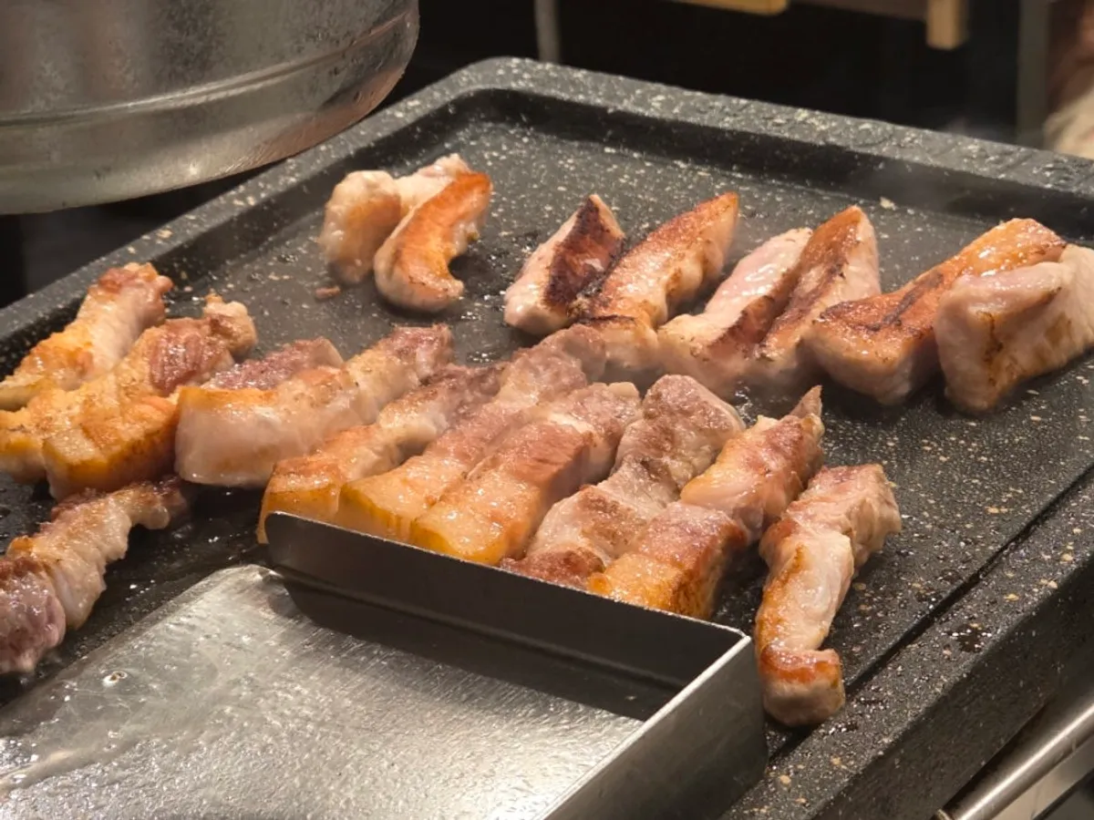 Pork belly and pork jowl grilling on the stone griddle