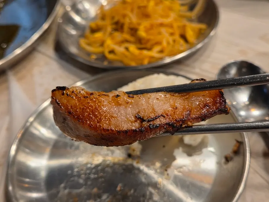 Grilled kimchi with a piece of pork jowl