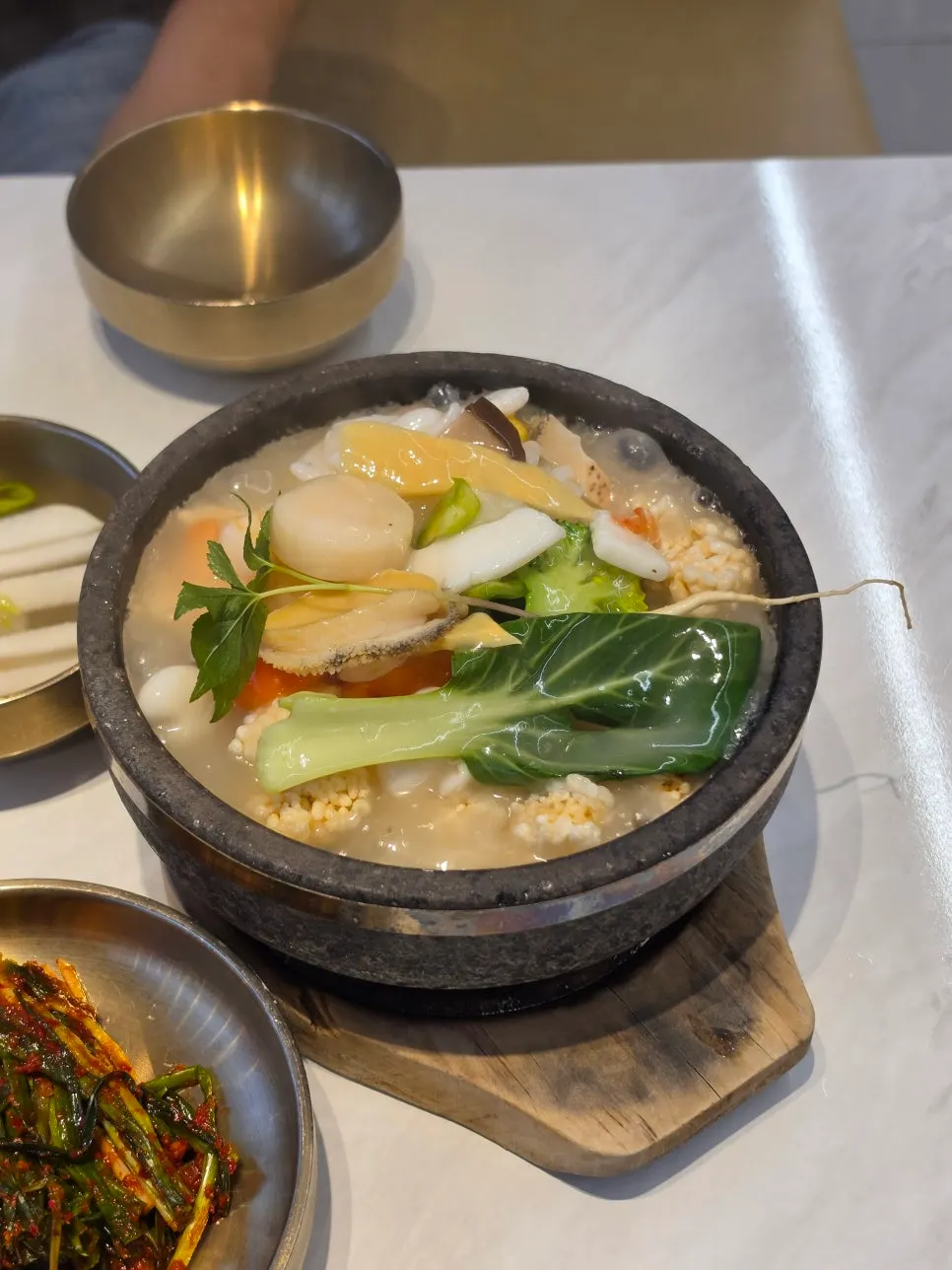 Close-up of the nurungjitang packed with seafood