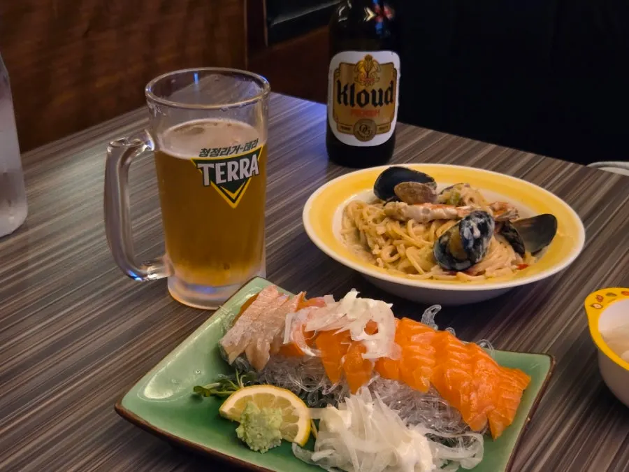 Side dishes and drinks at Hanamato, an izakaya in Sangam DMC