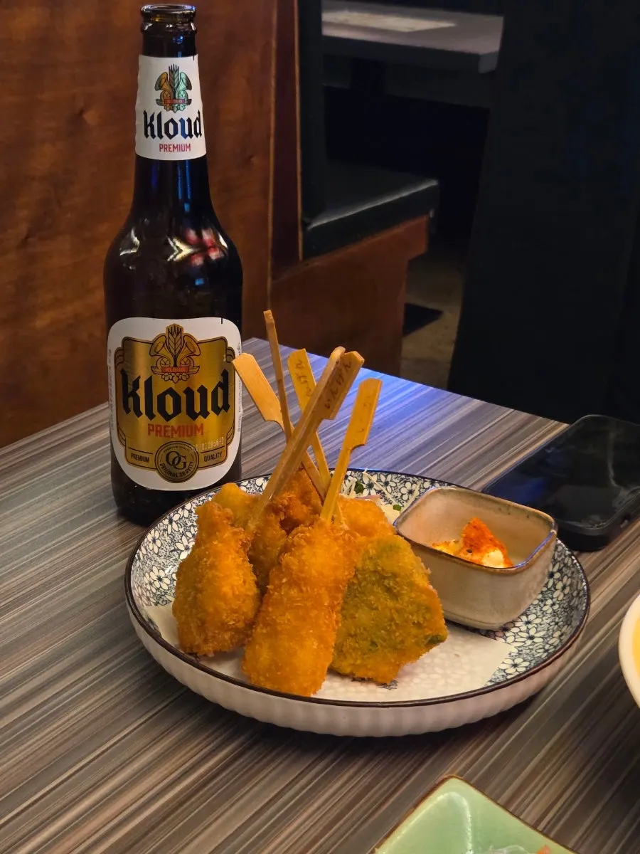 A glass of beer enjoyed with salmon sashimi